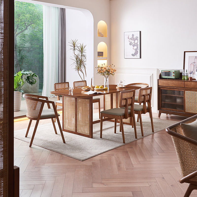 Waldron Rattan Dining Table Set lifestyle view with oak dining table and 8 chairs