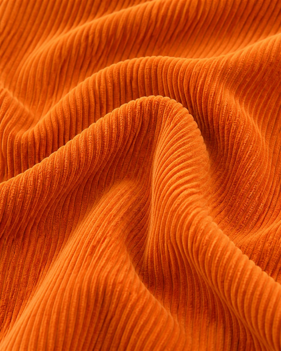 Makhmud orange corduroy fabric close-up